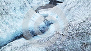 Close-up view of the blue ice with streaming water on the jokulsarlon glacier in Iceland