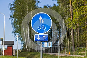 Close up view of blue road sign for pedestrians and bicycles lane.