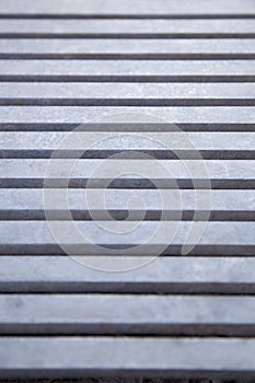Close up view of a blueish metal grate