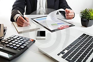 Close up view of bookkeeper or financial inspector hands making report, calculating or checking balance.