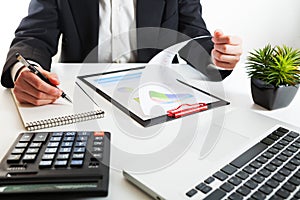 Close up view of bookkeeper or financial inspector hands making report, calculating or checking balance.