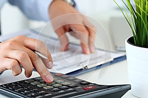 Close up view of bookkeeper hands calculating balance