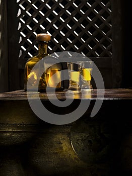 Anejo and glasses on color background photo