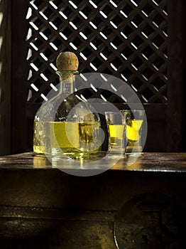 tequila anejo and glasses on color background photo