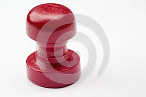 A close-up view of a bright red rubber stamp on a white surface