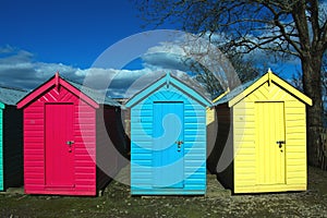 Close up view, brightly painted beach huts at the small village of Abersoch, Wales