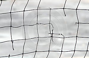 Close-up view of a broken volleyball net