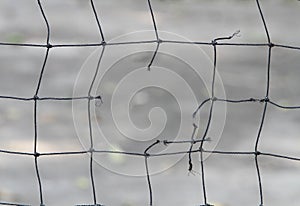 Close-up view of a broken volleyball net