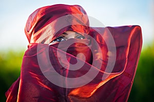 Close up view of brown woman eyes framed by headscarf