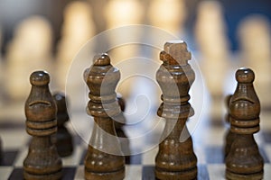 close up view of brown wooden pawns of chess