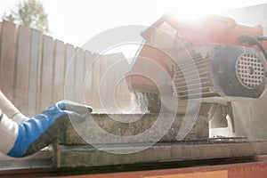 Close up view of a building contractor using an angle grinder or