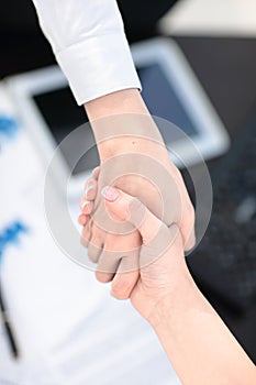 Close up view of business partnership handshake concept.Photo of two businessman handshaking process.Successful deal