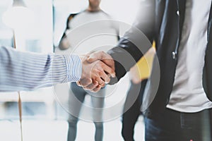 Close up view of business partnership handshake.Concept two coworkers handshaking process.Successful deal after great