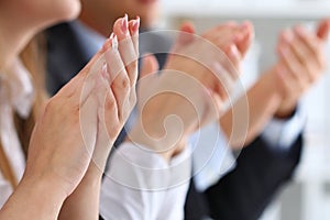 Close up view of business seminar listeners clapping hands