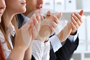 Close up view of business seminar listeners clapping hands