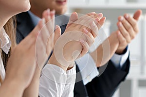 Close up view of business seminar listeners clapping hands