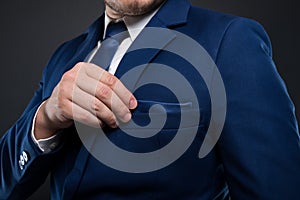 Close-up view of businessman fixing his pocket square