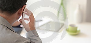 Close-up view of businessman making phone call with his customer