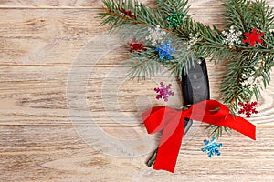 Close-up view of car keys with red bow as present on wooden background