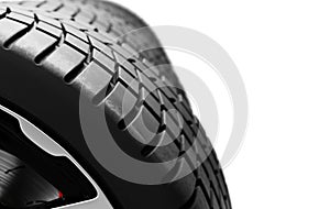 Close-up view of car tire tread on high-end wheel isolated