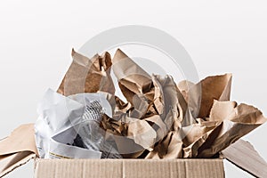 close up view of cardboard box with papers inside isolated on white