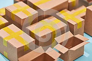 Close up view of cardboard postal boxes on blue background.