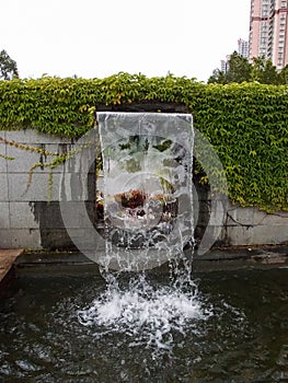 Close-up view of a cascading feature water fountain in a public park.