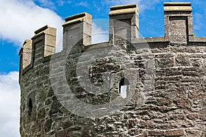 Close-up view of castle turret with sniper holes