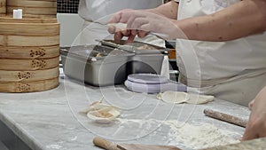 Close-up of view of the chef making xiao long bao in the kitchen