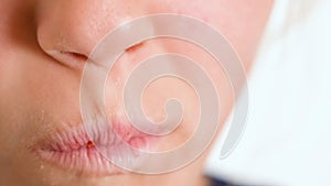 A close-up view of a child happily eating a doughnut. A child eats a donut. Fast food and unhealthy food.