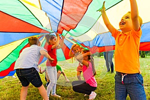 Close up view of children under the huge rainbow cover