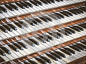 Close up view of a church pipe organ with four keyboards