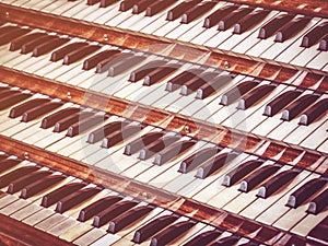 Close up view of a church pipe organ with four keyboards