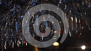 Close-up view of clean washed and polished glasses for wine and other alcoholic drinks hanging over the bar counter photo