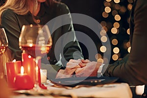 Close up view, closeness of the people. Young lovely couple have romantic dinner indoors together