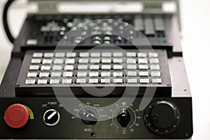 Close up view of CNC lathe machine control panel