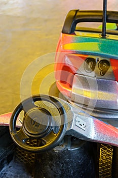 Close-up view of the cockpit of a colorful bumper car in a funfair