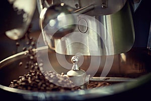 Close up view of coffee beans roasting in machine