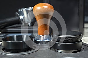 Close-up view of coffee tamper and portafilter photo