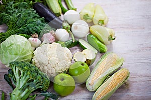 Close up view of collection of fresh green vegetables on white r