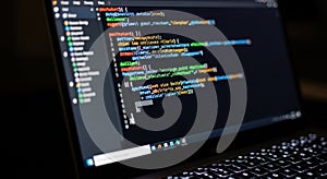 Close up view of colorful code on a computer screen with keyboard in the foreground