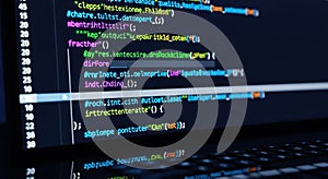 Close-up view of colorful computer code glowing on a screen representing technology and programming