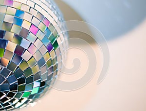 Close up view of colorful disco ball with multicolored reflections. Preparing for a fun night party or holiday at home