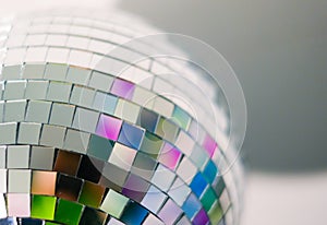 Close up view of colorful disco ball with multicolored reflections. Preparing for a fun night party or holiday at home