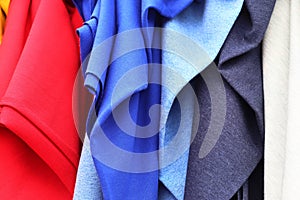 Close up view on colorful hanging and folded fabrics and textiles in high resolution found on a fabrics market in Flensburg