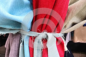 Close up view on colorful hanging and folded fabrics and textiles in high resolution found on a fabrics market in Flensburg