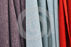 Close up view on colorful hanging and folded fabrics and textiles in high resolution found on a fabrics market in Flensburg