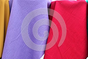 Close up view on colorful hanging and folded fabrics and textiles in high resolution found on a fabrics market in Flensburg