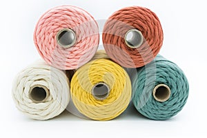Close-up view of the colorful single strand cotton cords for macrame DIY handcraft on white background