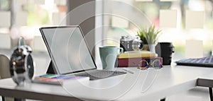 Close-up view of comfortable designer workplace with blank screen tablet and office supplies